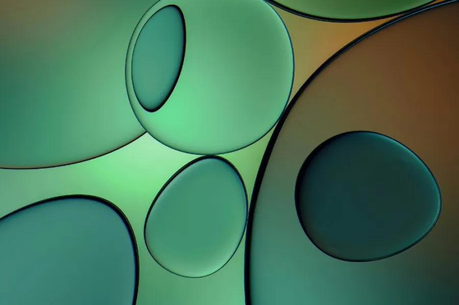 Imagem abstrata de bolhas sobrepostas em tons de verde e laranja