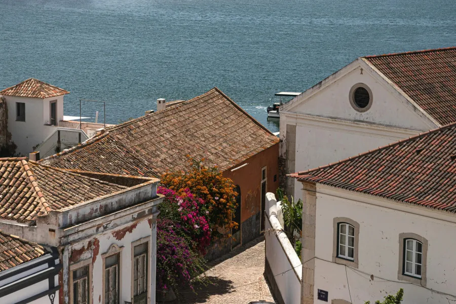 Diversas casas junto ao mar, numa zona de férias, ilustrando os locais onde os famosos costumam compram casas em Portugal.